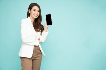 Portrait of Asian business woman showing or presenting smartphone or mobile phone application isolated over green background, Asian Thai model