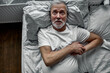 © alfa27 - elderly man is suffering from heart attack on bed, holding hands on chest, looking up