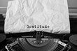 Text Gratitude typed on retro typewriter