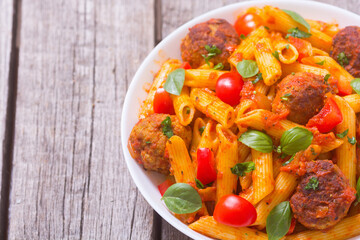 Wall Mural - Italian penne pasta with meatballs and tomatoes