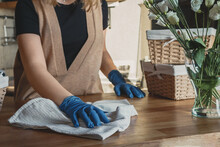 Girl Spring Cleaning In The Kitchen. Piles Kitchen Towels In Baskets. Spring Cleaning, Decluttering, Cleaning Space, Cleaning Agency