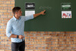 Male caucasian teacher teaching mathematics in the classroom at school