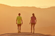 © Albert Garrido/ADDICTIVE STOCK - Back view of male and female runners walking on hilltop in mountains at sundown in summer