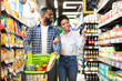 © Prostock-studio - Cheerful Black Spouses Choosing Food In Grocery Store