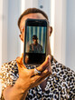 © Albert Morcillo/ADDICTIVE STOCK - African American male in stylish outfit taking photo on selfie camera on street on sunny day