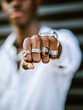© Albert Morcillo/ADDICTIVE STOCK - Blurred anonymous African American stylish male showing fist with various trendy silver rings