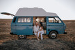 © Alejandro Diaz/ADDICTIVE STOCK - Loving couple of travelers sitting in parked van while spending summer vacation looking at each together