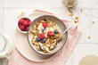 © Anastasia Nurullina/ADDICTIVE STOCK - A bowl of granola with nuts and oats served with berries and milk