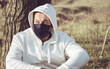 © bogdan vacarciuc - Man wearing a white sweatshirt and a medical mask to protect against coronavirus infection