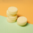 © Fernando Valencia/ADDICTIVE STOCK - Natural round shaped soap arranged on two colored background in studio