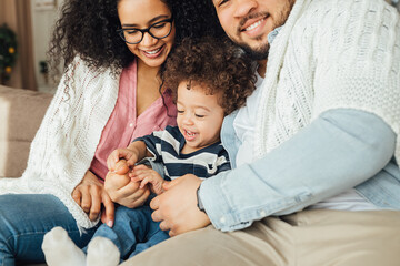 Wall Mural - Close up of happy family spending time together at home