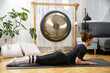 © zlikovec - Fit active woman stretching, doing pilates and yoga fitness exercise in room at home.