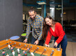 © Jose Carlos Cerdeno/ADDICTIVE STOCK - Cheerful young multiethnic people in casual clothes having fun and playing table football together