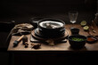 © Julianne Medeiros/ADDICTIVE STOCK - High angle of stack of old fashioned metal plates placed on wooden table with various utensils in dark country house