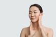 © Асель Иржанова - facial care, beautiful asian woman skin care on white background copy space youth and skin health