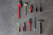 © Manuel Ruiz/ADDICTIVE STOCK - Top view of shabby metal repair tools arranged in rows on floor of garage