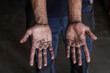 © Manuel Ruiz/ADDICTIVE STOCK - High angle of crop unrecognizable male mechanic showing dirty hands while working in repair service workshop