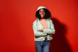 © Manuel Ruiz/ADDICTIVE STOCK - Modern ethnic woman with Afro hairstyle wearing casual denim with jacket and hood on vivid red background