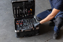 From Above Unrecognizable Male Technician Picking Screwdriver Bits From Tool Box While Working In Garage