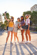 © Manuel Ruiz/ADDICTIVE STOCK - Full body of cheerful trendy young multiracial girlfriends in sunglasses with backpacks and skateboard taking selfie on mobile phone while gathering together on urban square in summer day