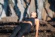 © Pablo Garcia/ADDICTIVE STOCK - Calm female with closed eyes practicing yoga in Purvottanasana on sunny day in rocky terrain