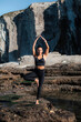 © Pablo Garcia/ADDICTIVE STOCK - Flexible female in sportswear balancing on leg in Vrksasana with raised arms while doing yoga in mountains in summer