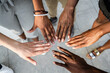 © Rafa Cortes/ADDICTIVE STOCK - High angle of crop unrecognizable multiracial company of friends stacking hands together on street on sunny day