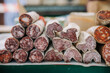 © Raquel Arocena/ADDICTIVE STOCK - Various types of delicious spicy aromatic cured meat sausages stacked on counter of local farmers market