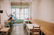 © Raquel Arocena/ADDICTIVE STOCK - Cozy interior of confectionery cafe with simple furniture and vintage lamp in light room with old fashioned door