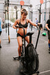 © Raquel Arocena/ADDICTIVE STOCK - Pregnant female athlete exercising on air cycling machine during training in modern gym