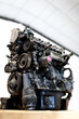 © Sergio Victor Vega/ADDICTIVE STOCK - Low angle of dirty car engine placed on table in bright facility of car service
