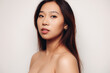 © Victor Torres/ADDICTIVE STOCK - Portrait of naked young Chinese woman looking at camera over white background