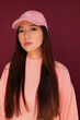 © Victor Torres/ADDICTIVE STOCK - Portrait of young asian woman in the studio looking at camera. She is wearing pink clothes with serious expression