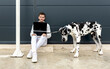 © Sergio Victor Vega/ADDICTIVE STOCK - Male freelancer sitting on street with Great Dane dog and working on remote project via laptop
