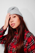 © Victor Torres/ADDICTIVE STOCK - Close-up portrait of cheerful Asian young woman covering her face with her hand