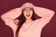 © Victor Torres/ADDICTIVE STOCK - Portrait of happy young asian woman in the studio wearing pink clothes over garnet background