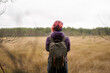 © Sergey Mironov/ADDICTIVE STOCK - Back view of unrecognizable female explorer with pink hair and in warm clothes standing in dry field in Sestroretsk admiring landscape