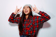 © Victor Torres/ADDICTIVE STOCK - Close-up portrait of cheerful Asian young woman with rock sign