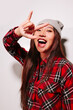 © Victor Torres/ADDICTIVE STOCK - Close-up portrait of cheerful Asian young woman with rock sign