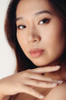 © Victor Torres/ADDICTIVE STOCK - Portrait of naked young Chinese woman looking at camera over white background