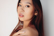 © Victor Torres/ADDICTIVE STOCK - Portrait of naked young Chinese woman looking at camera over white background