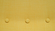Home Upholstered Furniture Concept. Yellow Fabric Background. Three Round Ornament Details In A Row.