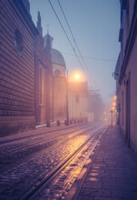 Picturesque Old Town Dominikanska Street And Holy Trinity Church On Foggy Night, Krakow, Poland