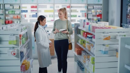 Wall Mural - Pharmacy Drugstore: Caucasian Woman Chooses to Buy Medicine Professional Asian Pharmacist Advising, Consulting, Recommending Customer the Best Option. Modern Pharma Store Health Care Products