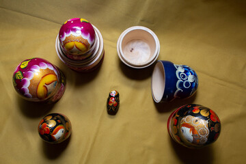 many Russian nesting dolls in one place on a yellow background 