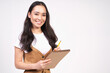 © Svitlana - A cheerful young Korean woman with a notebook in her hands smiles.