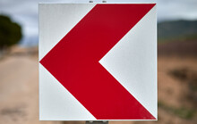 Traffic Sign With A Red Arrow Indicating A Curve