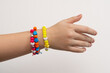 © Victor - Colorful bead bracelet hand of a young girl