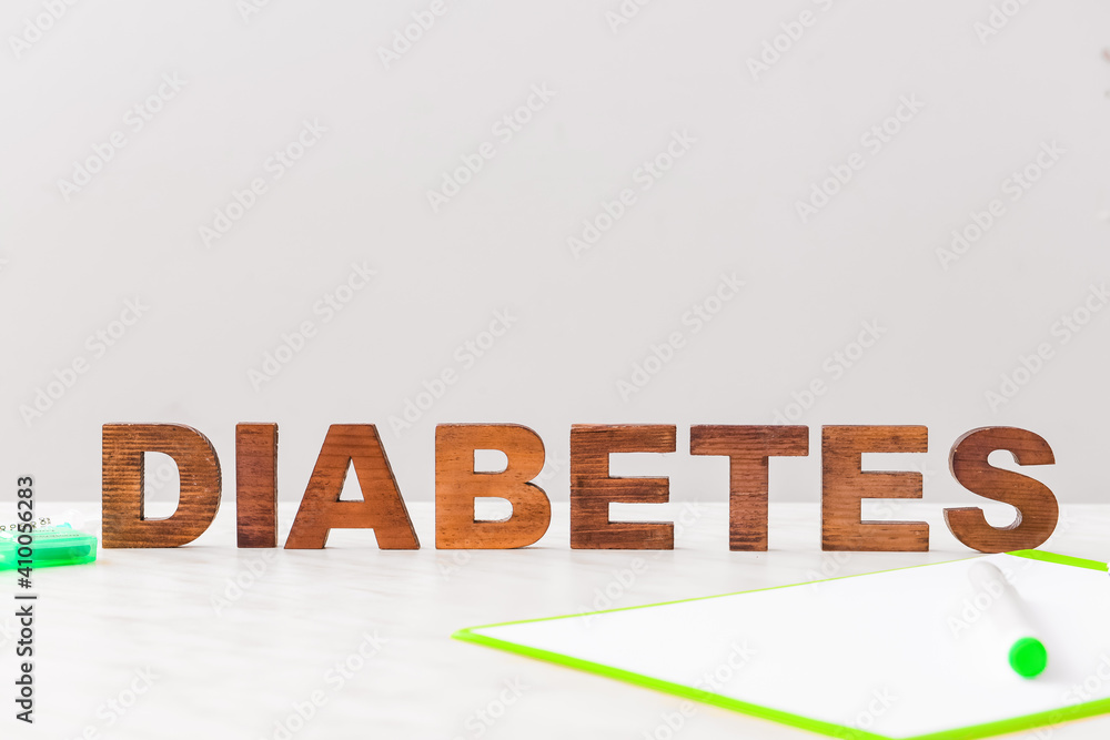 Word DIABETES on table against grey background