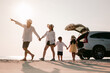 © Garun Studios - Asian family on the beach.Vacation time. Happy father, mother and son enjoying road trip the summer holidays.Parents and children are sitting on a hatchback with a sea background.